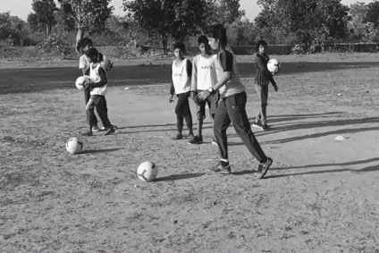 Tribal Children Learning Football Skills